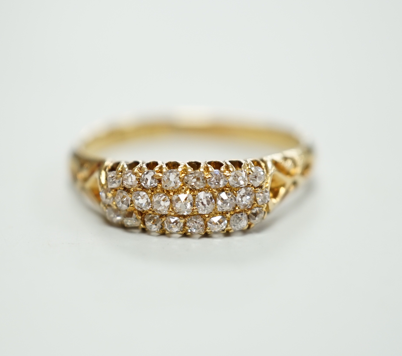 An 18ct and three row diamond cluster set ring, size P/Q, gross weight 3 grams.